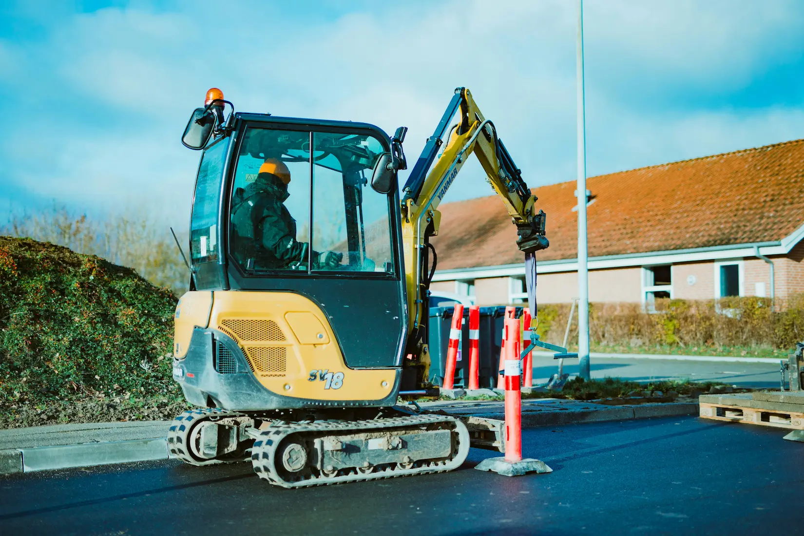 Mini excavator with attachments ready for site work