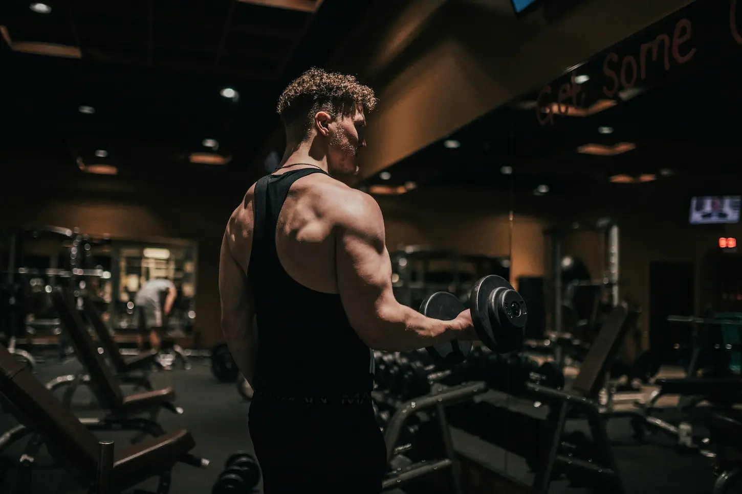 Boutique fitness founder reviewing startup finance figures inside a modern training studio